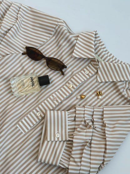 Striped beige and white shirt with sunglasses, a perfume bottle labeled "ANVIL," and pearl earrings on top. Elegant and stylish arrangement.